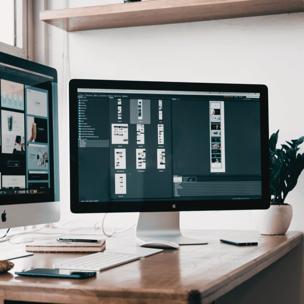 Website wireframe and layout mockups on dual screens — a look into structured, responsive web design workflows.